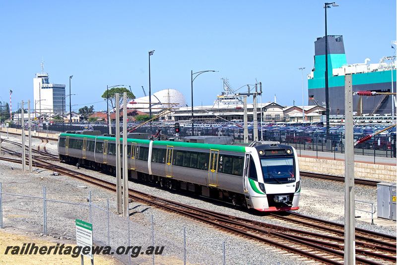 P24323
EMU set 58, comprising BEA, BEB, BET class railcars, ship, control tower, port in background, Fremantle, ER line, side and end view
