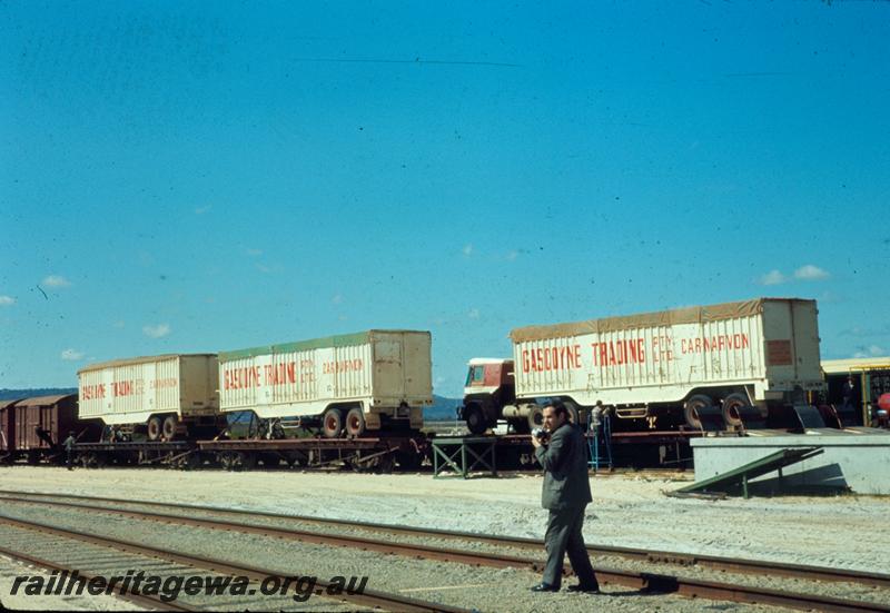 T00493
Gascoyne Traders Semi trailer trucks loaded onto QCP class bogie flat wagons, Kewdale yard, one of the wagons painted  in the black livery
