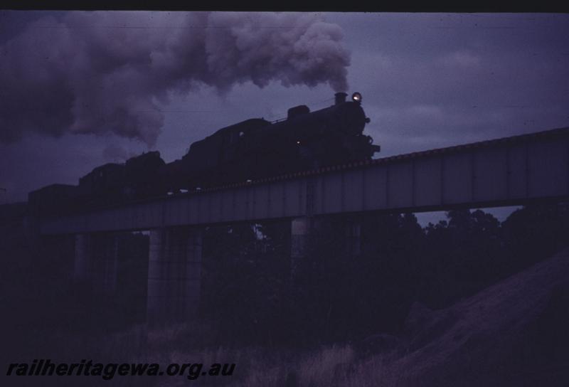 T01207
Double headed locos, steel girder bridge, early morning departure on goods train from Collie, BN line (very dark image)
