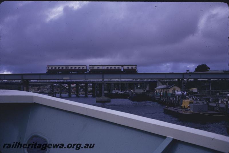 T01712
Railcar set, Fremantle Bridge, taken from boat approaching the bridge.
