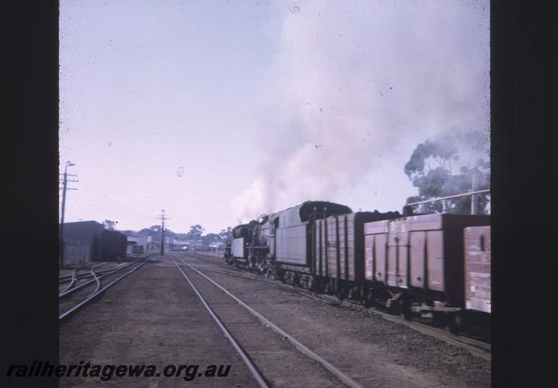 T02066
Double headed loco on departing goods train, goods yard, track work
