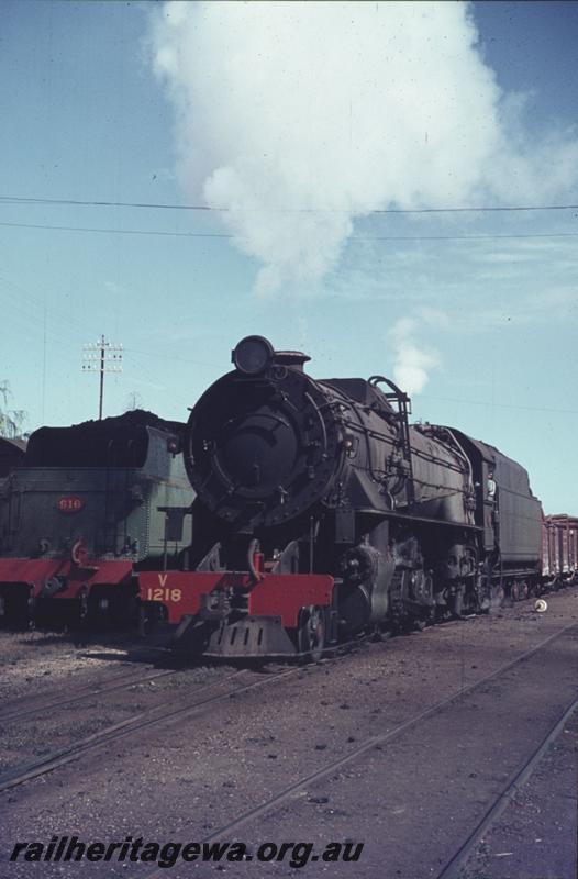 T02327
V class 1218, front and side view heading No.171 goods out of Bunbury, SWR line, rear of tender W class 916, cheese knob, sleepers covered in ballast in yard.
