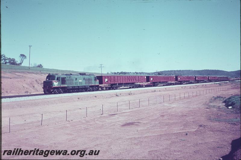 T02409
X class, goods train, includes five Commonwealth Railways (CR) standard gauge GL class and VE class bogie open wagons which had been constructed at the Commonwealth Engineering (Comeng) plant in Bassendean being carried upon QU class flat wagons
