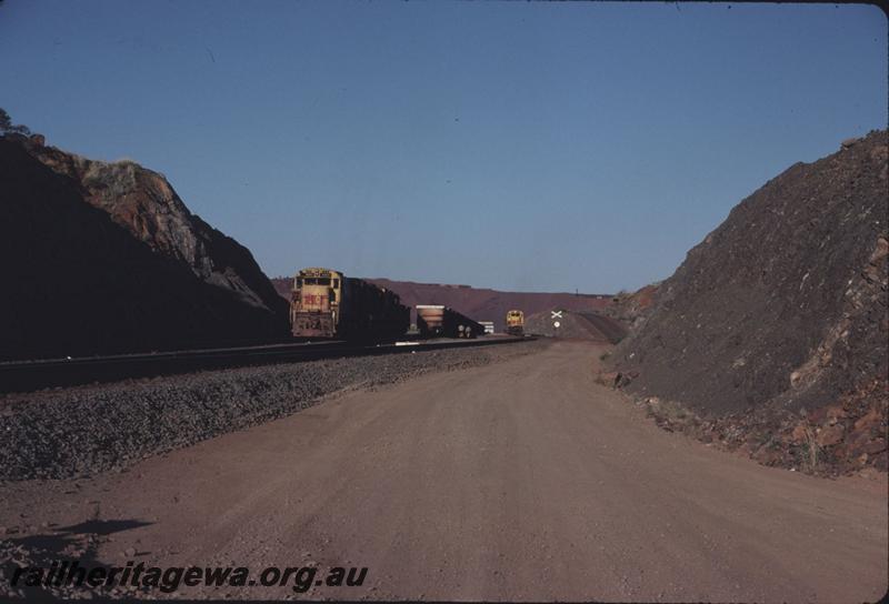 T02899
Hamersley Iron Alco locomotives M636 class 4043 triple heading, shunts a pair of cars, M636 class 4054 in the background, Paraburdoo
