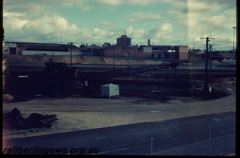 T03300
Turntable, steam crane East Perth temporary loco depot. Railway house at 34 Cheriton Street in background, 
