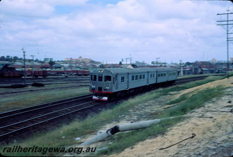 T03830
ADK/ADB class railcar set, East Perth, passing the partially demolished loco depot
