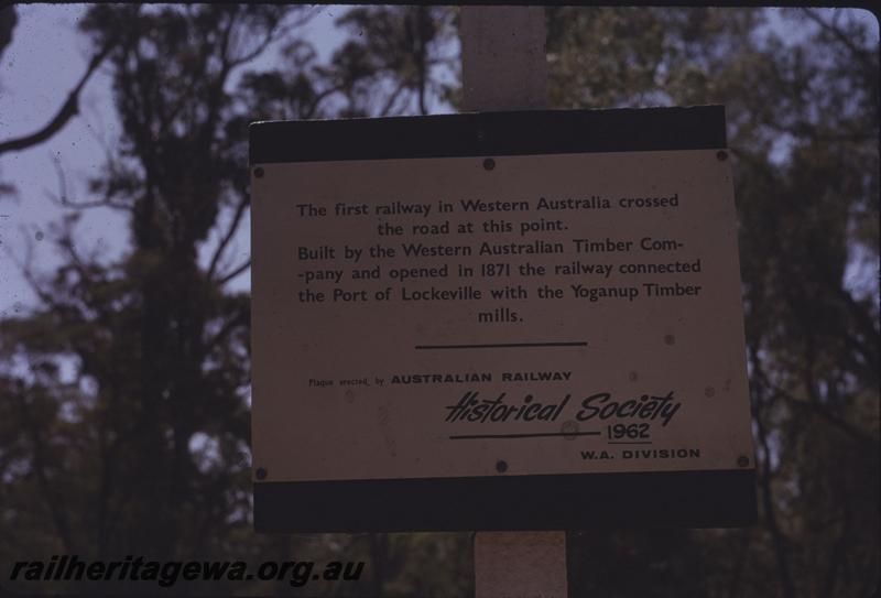 T03945
Sign erected by the ARHS WA Div. to point out that the first railway in WA crossed the road at that location
