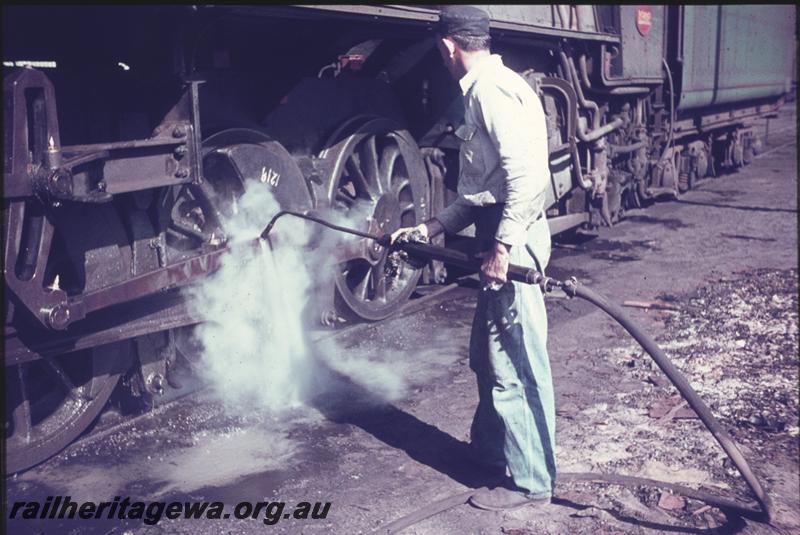 T04219
Worker steam cleaning a loco's running gear, Perth
