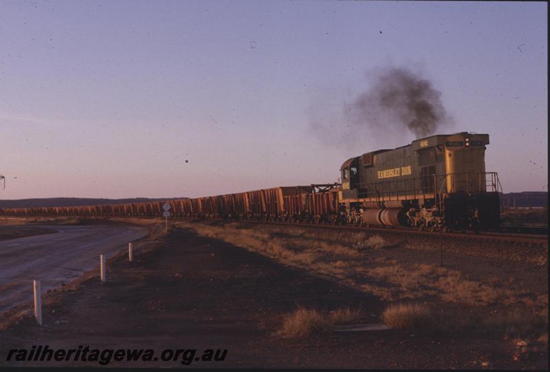 T04226
Hamersley Iron Alco locomotive M636 4042 leads an empty ore rake with compressor car back from Parker Point, Dampier, 7 Mile, RIO line, 
