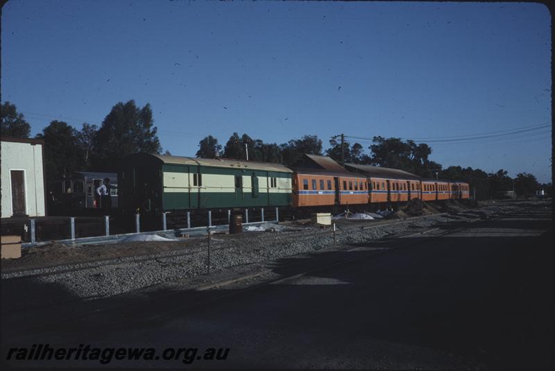 T04263
ZJA class passenger brakevan coupled to a train of railcars in orange Westrail livery, Armadale station, SWR line, maybe the opening of the new station?
