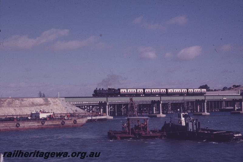 T04271
DD/DM class on suburban passenger train crossing the new Fremantle railway bridge, side on distant view.
