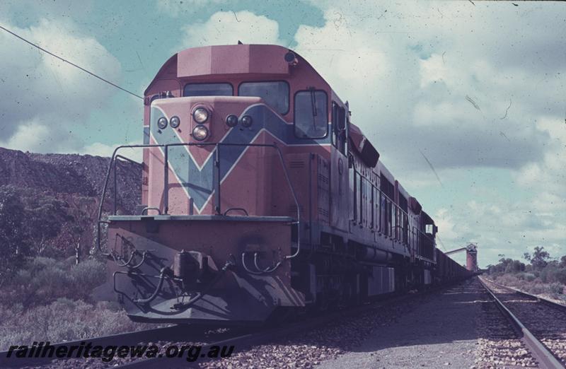 T04292
L class 262 in Westrail orange livery double heading with another L class on an ore train being loaded, front and side view
