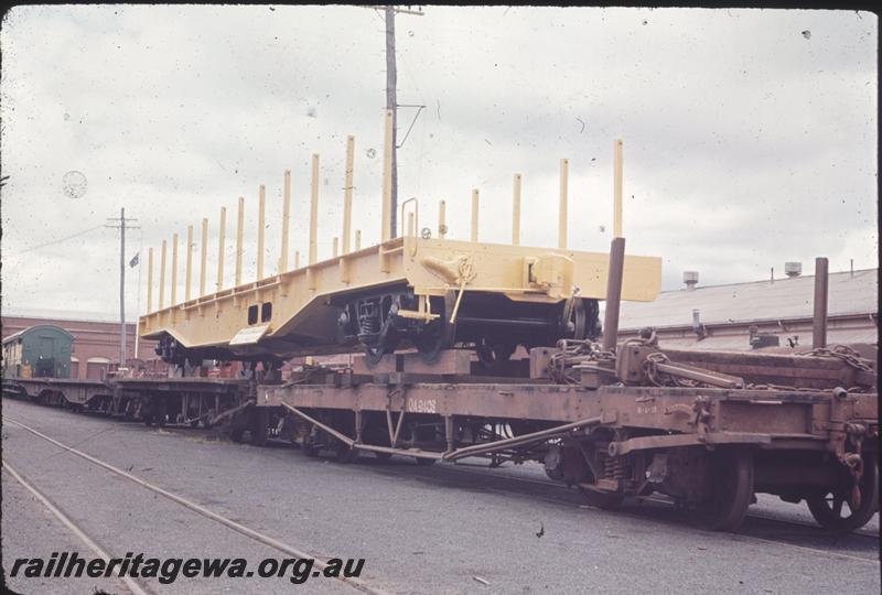 T04304
WF class standard gauge flat wagon, (later reclassified to WFDY), newly painted being carried on QA class 9403 and other narrow gauge flat wagons, Midland Workshops forecourt 
