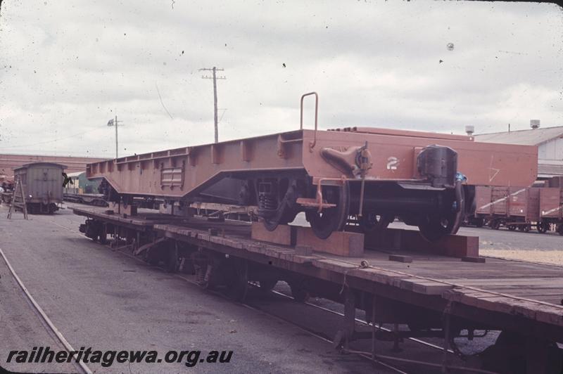 T04306
WF class standard gauge flat wagon, (later reclassified to WFDY), newly painted in red oxide undercoat being carried on narrow gauge flat wagons, Midland Workshops forecourt 
