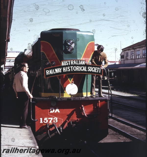 T04329
DA class 1573, Perth Station, head on view with ARHS members, Dave Merrin and Alan Tilley adjusting the headboard, ARHS tour train
