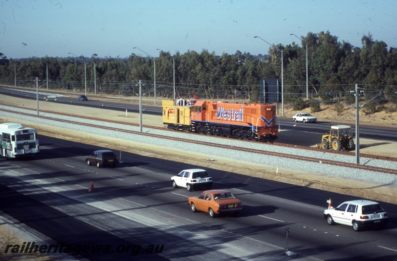 T04338
DB class diesel locomotive in Westrail orange livery hauling SD class 580 overheard inspection vehicle.( Previously a ZS class brakevan) being  used for the inspection of overhead wiring, NSR line.
