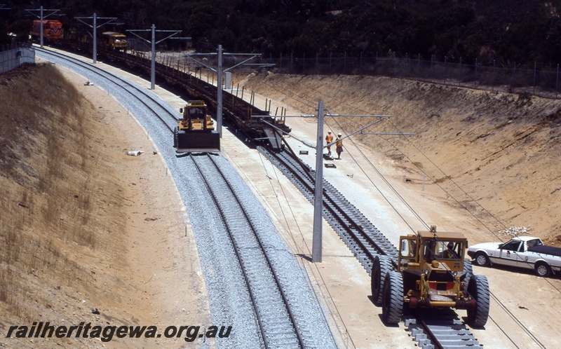 T04339
1 of 2, A class 1506 diesel locomotive in Westrail orange livery, track laying, Joondalup, NSR line..
