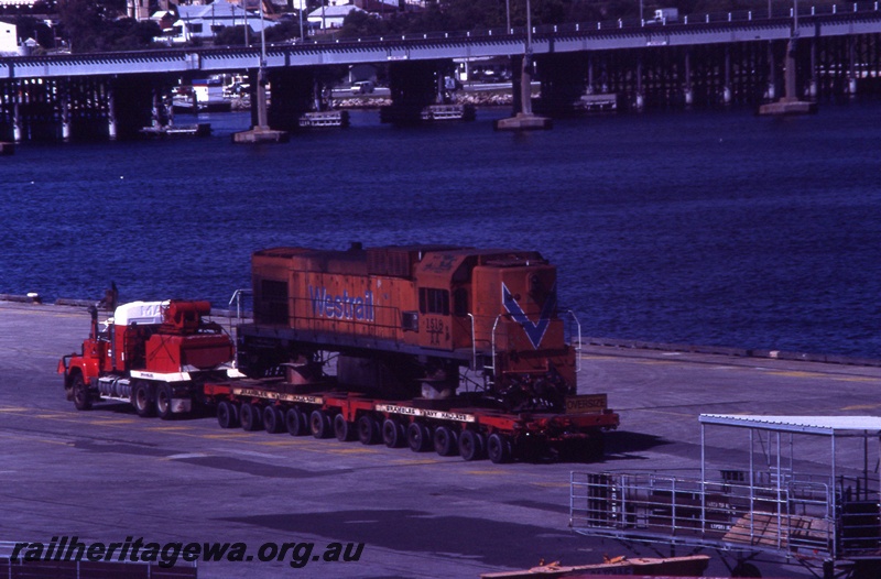 T04347
2 of 2, AA class 1518 diesel locomotive in Westrail orange livery on low loader, Fremantle wharf, bound for NZ.
