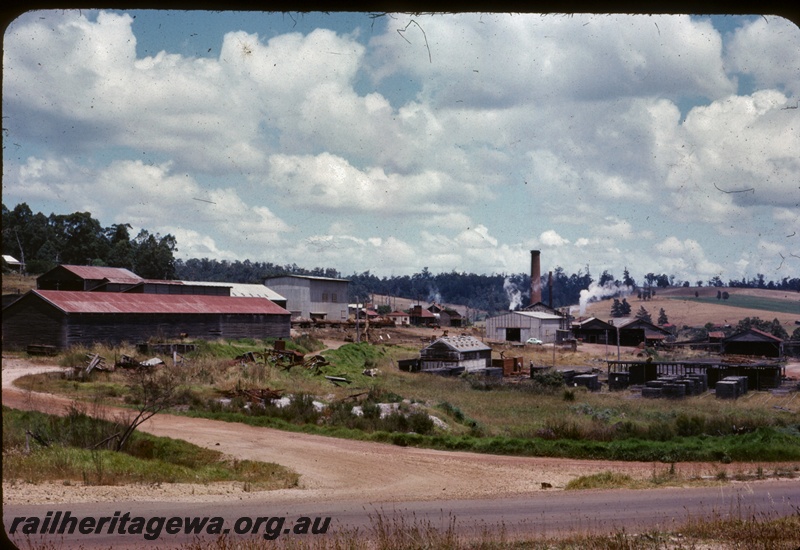 T04359
Pemberton Saw Mill, bitumen and dirt roads in foreground, various buildings in middle distance, forest behind, PP line
