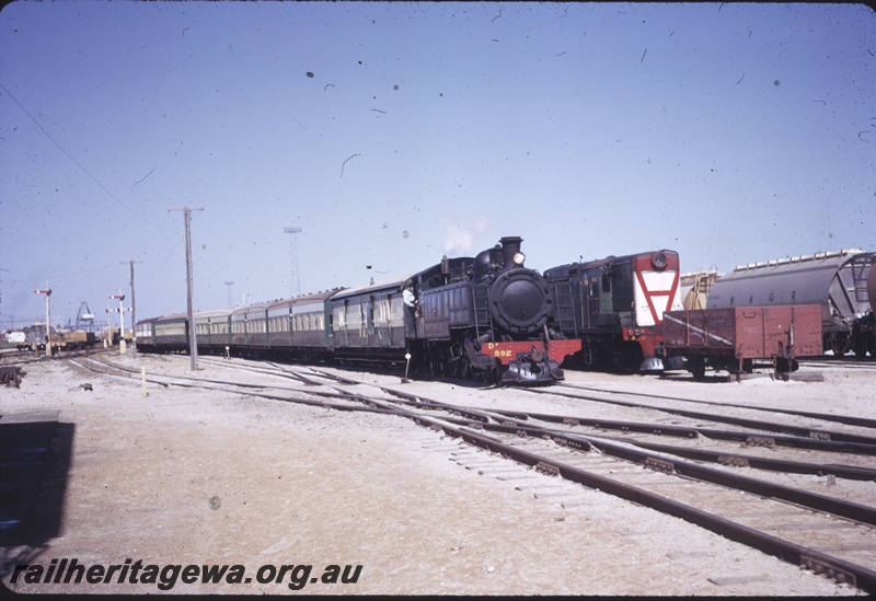 T04374
DD class 592, heading passenger train, maroon diesel with inverted A on white face, signal posts, Leighton yards, ER line
