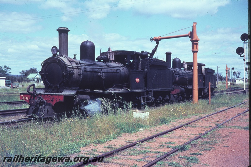 T04454
G class 118 steam locomotive, hauling another G class locomotive, taking water at Pinjarra. SWR line, both locomotives were enroute to Forrestfield for disposal.
