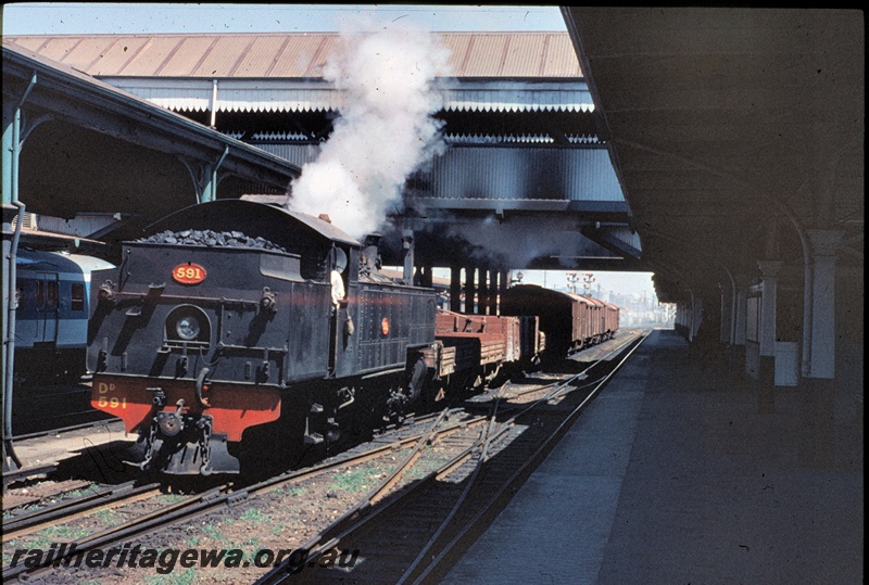 T04485
DD steam locomotive 591 operating bunker leading through Perth Station with Midland bound freight train. This scene has changed over the years.
