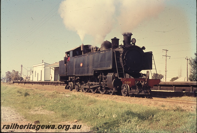 T04488
DD class 594 steam locomotive at Welshpool on the local shunt train, SWR line, note the station buildings on the platform and the wooden structure forming the platform uprights and facing.
