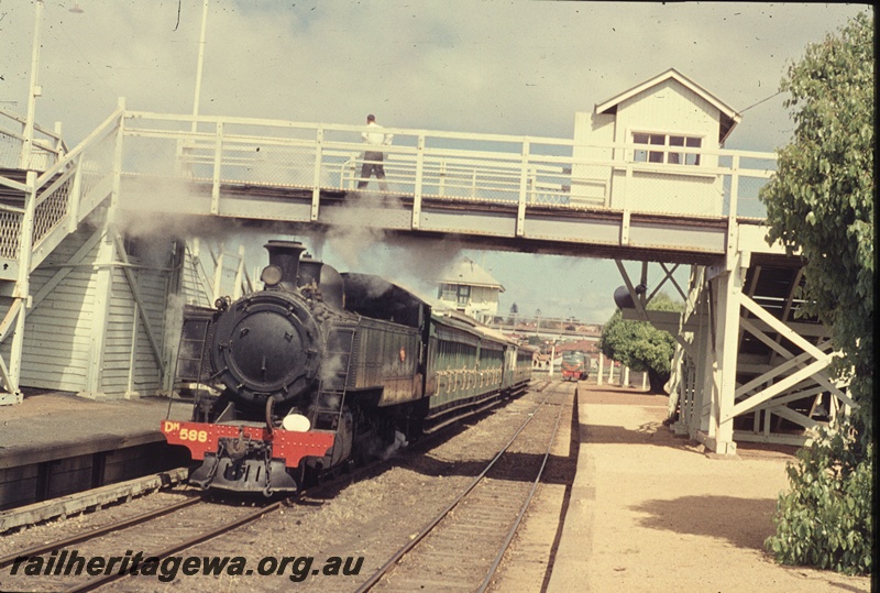 T04489
DM class 588 steam locomotive pictured working a Royal Show Special at Claremont. An unidentified X class in the far background waiting to carry out its next task.
