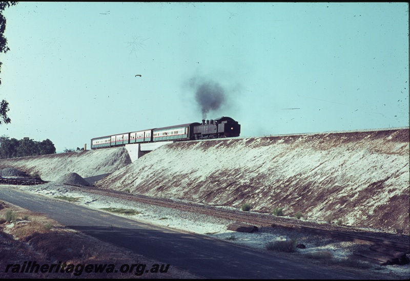 T04492
An unidentified DM/DD class steam locomotive working the 0752 hours suburban passenger from Armadale travelling over the Kenwick flyover, SWR line.
