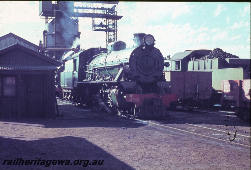 T04508
W class 906 steam locomotive at Bunbury locomotive depot with an unidentified PM class steam locomotive two roads across. The coaling stage in the background, SWR line.
