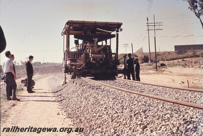 T04614
A Ballast Tamping machine operating on the new standard gauge line in the Soundcem area.
