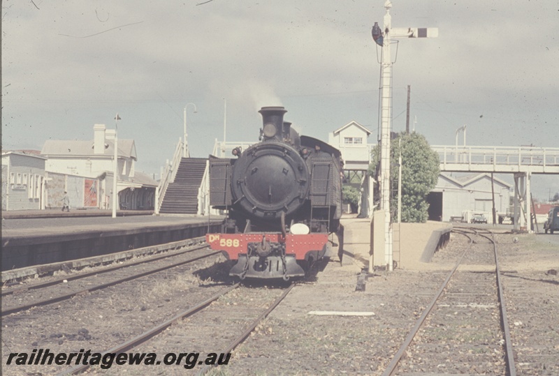 T04623
Dm class 588 steam locomotive at the head of a Royal Show special, rear view of a signal,footbridge, partial view of the goods shed, Claremont, ER line.
