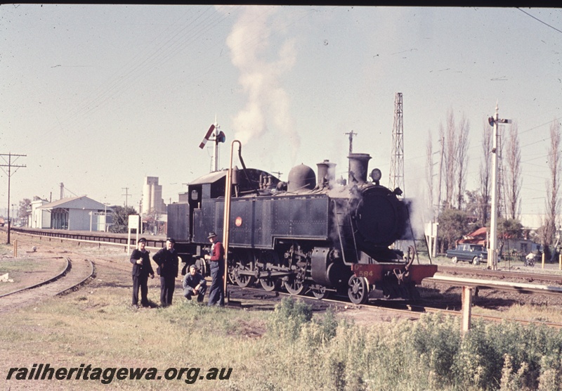 T04637
DD class 584 steam locomotive, water standpipe, Welshpool, crew standing around while the loco takes water, side and front view.
