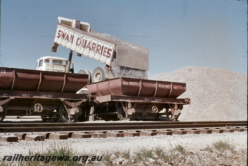 T04647
Loading a WSJ class 4 wheeled ballast hopper with metal ballast at Kenwick.
