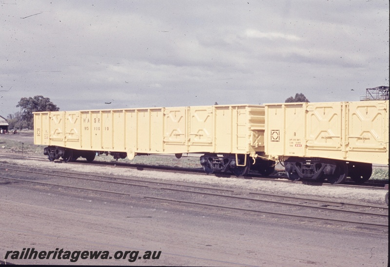 T04669
K class standard gauge diesel locomotive coupled to a WF class flat top wagon. The employee's wet weather equipment is on the front running boards of the loco.
