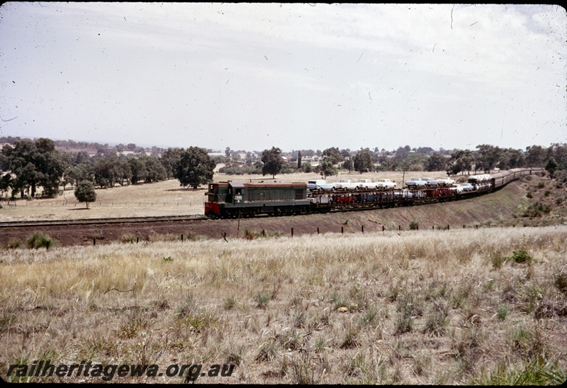 T04681
A class 1501 diesel locomotive at the head of The Westland Express in the eastern portion of the Darling Range. Note the goods vehicles at the front of the passenger carriages.
