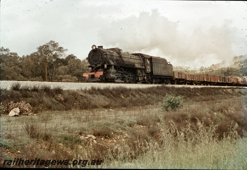 T04695
An unidentified V class steam locomotive at the head of a goods train probably on the Avon Valley line.
