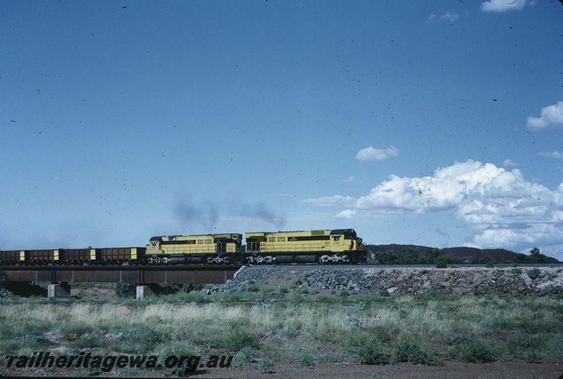 T04738
Cliffs Robe River (CRRIA) M636 class 1712 and M636 1710 crossing Miller Creek hauling an empty ore train to the Pannawonica mine. 
