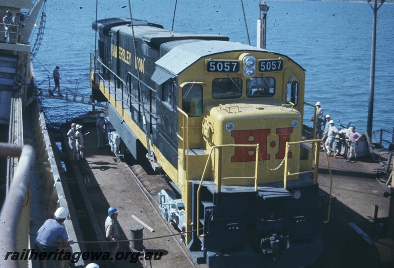 T04767
Hamersley Iron (HI) GE36-7 class 5057 (Goninan-GE) being lifted onto wharf from vessel MV Iron Baron at Dampier.
