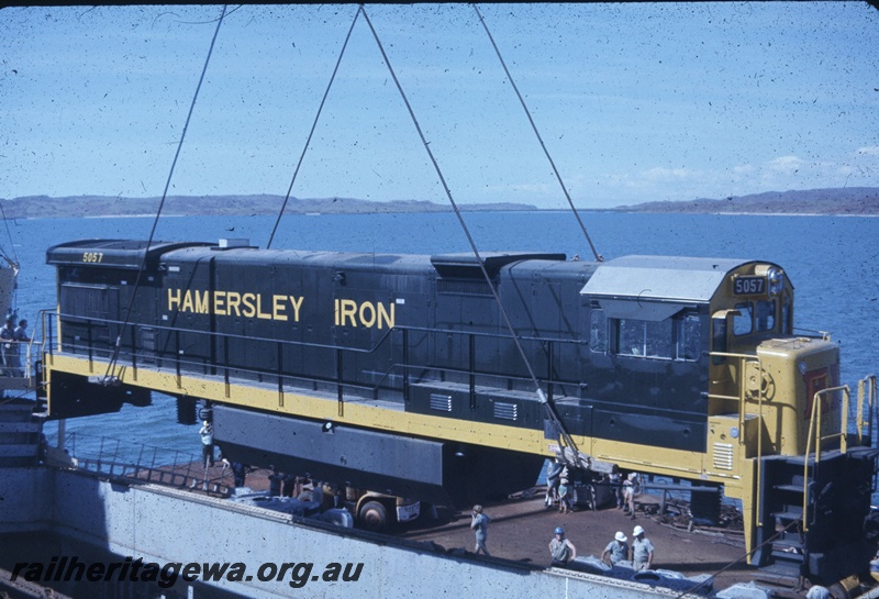 T04768
Hamersley Iron(HI) GE36-7 class 5057 (Goninan-GE) being lifted onto wharf from vessel MV Iron Baron at Dampier.
