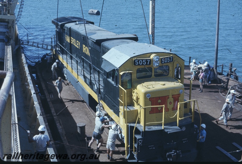 T04769
Hamersley Iron (HI) GE36-7 class 5057 (Goninan-GE) being lifted onto wharf from vessel MV Iron Baron at Dampier.
