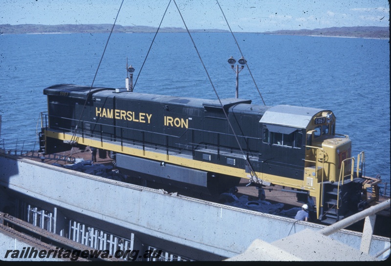 T04770
Hamersley Iron (HI) GE36-7 class 5057 (Goninan-GE) being lifted onto wharf from vessel MV Iron Baron at Dampier.

