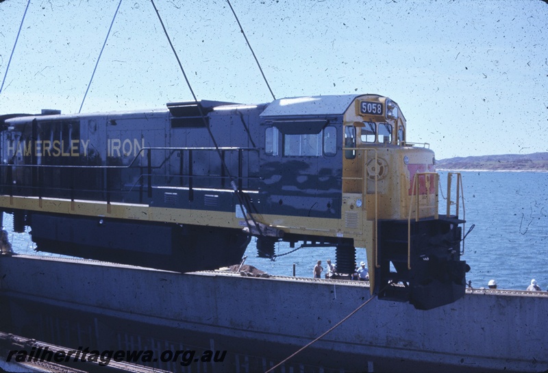 T04773
Hamersley Iron(HI) GE36-7 class 5058 (Goninan-GE) being lifted onto wharf from vessel MV Iron Baron at Dampier.
