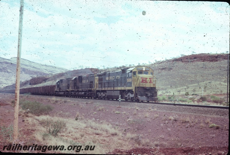 T04799
Hamersley Iron (HI) GE36-7 class 5059 leading 2 other locomotives on a loaded ore train.
