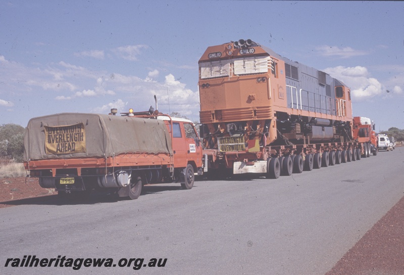 T04825
Goldsworthy Mining (GML) GML10 class on delivery road trip to Port Hedland, Great Northern Hwy near Newman.
