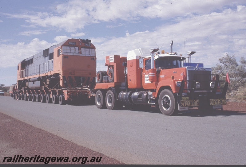 T04827
Goldsworthy Mining (GML) GML10 class on delivery road trip to Port Hedland, Great Northern Hwy near Newman.
