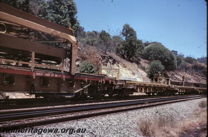T04855
Track maintenance train including flatbed wagons laden with sleepers, workers, Avon Valley line, side view
