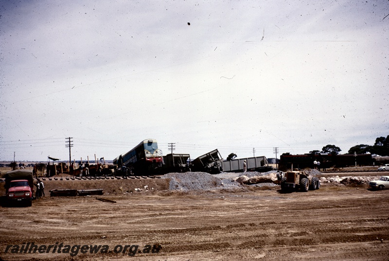 T04888
Derailment, H class loco and hoppers off track, workers, truck, excavator, cars, road crossing
