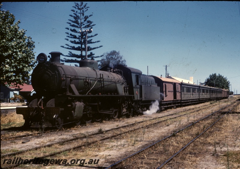 T04921
W class loco, on passenger train, country station, front and side view
