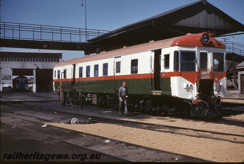 T04933
ADG class 607, another ADG class railcar in shed, fuelling point, point lever, worker, pedestrian overpass, East Perth depot, ER line
